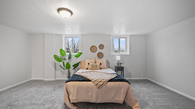 carpeted bedroom with multiple windows, baseboards, and a textured ceiling