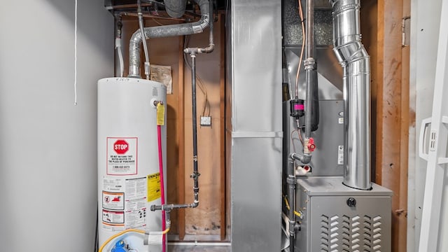 utility room featuring gas water heater