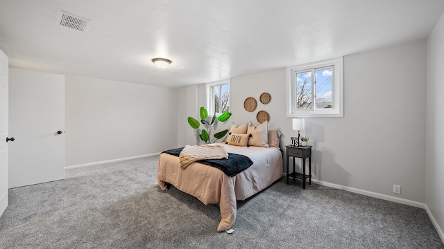 carpeted bedroom with visible vents and baseboards