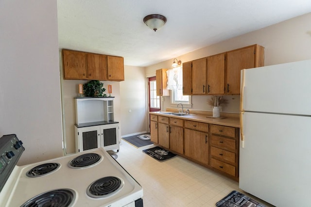 942 Lenox Ave, Mansfield, OH 44906 - kitchen featuring white appliances, light countertops, brown cabinets, and light floors