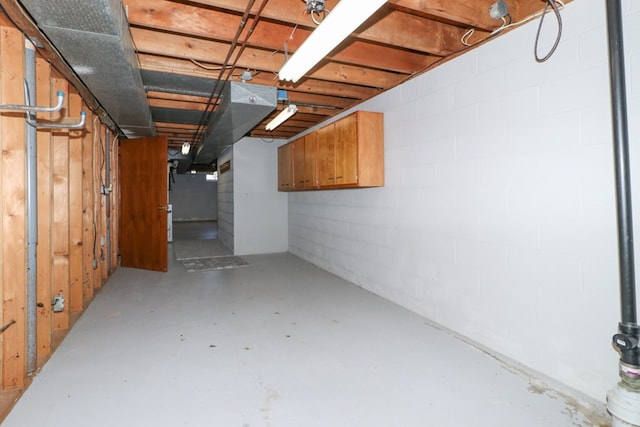 unfinished below grade area featuring concrete block wall