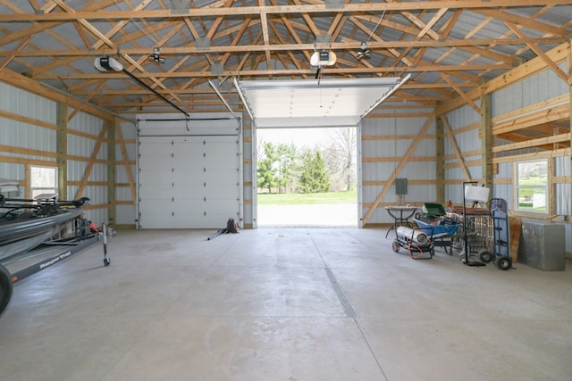 garage featuring a garage door opener and metal wall