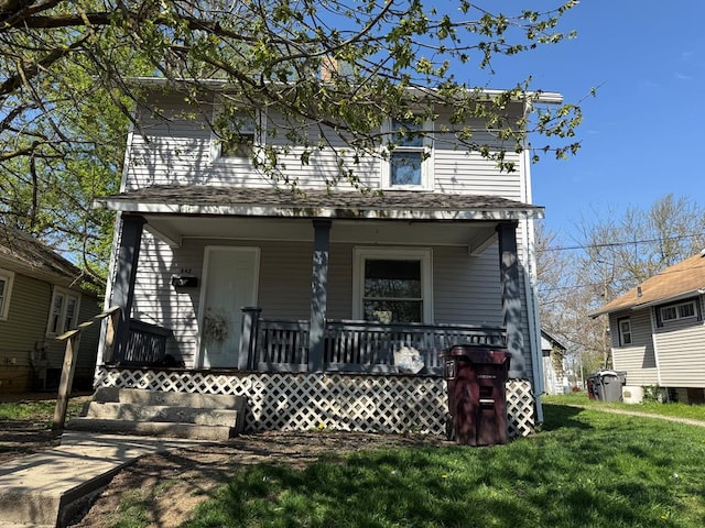 view of front of property featuring a porch and a front lawn