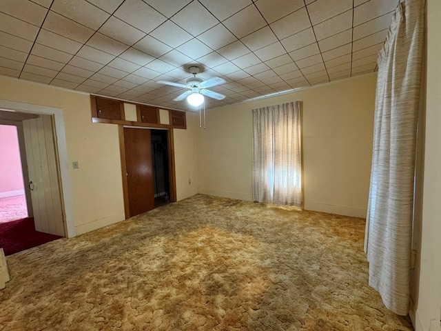 unfurnished bedroom with carpet, ceiling fan, and a closet