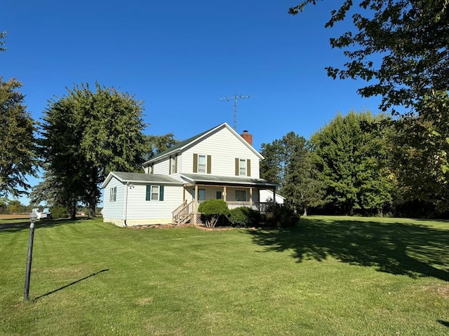 rear view of property with a porch and a yard