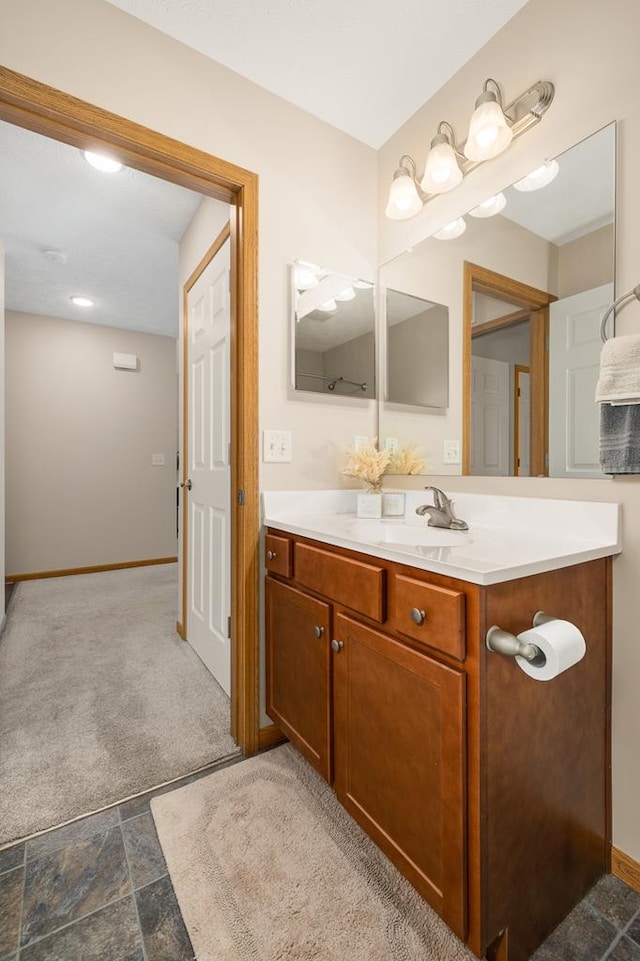 bathroom with vanity and baseboards
