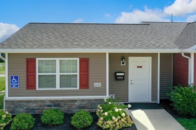 view of front of house with roof with shingles