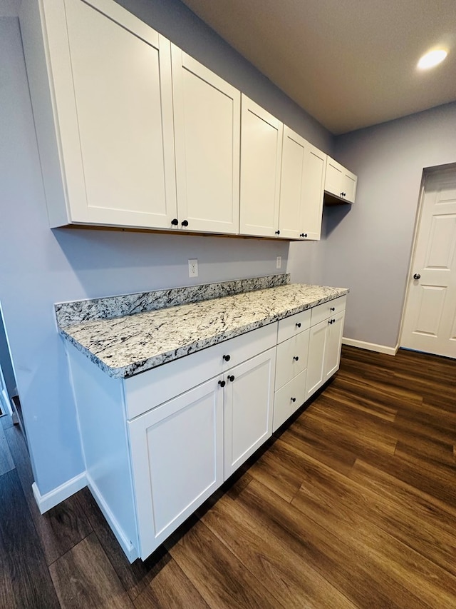 1030 Elm, Bucyrus, OH 44820 - kitchen with dark wood finished floors, light stone countertops, white cabinetry, and recessed lighting