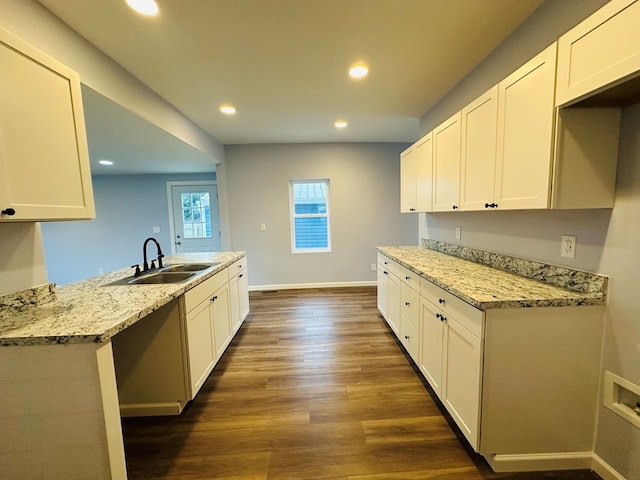 1030 Elm, Bucyrus, OH 44820 - kitchen featuring recessed lighting, dark wood finished floors, white cabinets, light stone countertops, and a peninsula