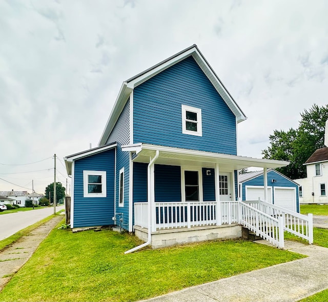 1030 Elm, Bucyrus, OH 44820 - view of front of home featuring a porch, a front lawn, a detached garage, and an outdoor structure