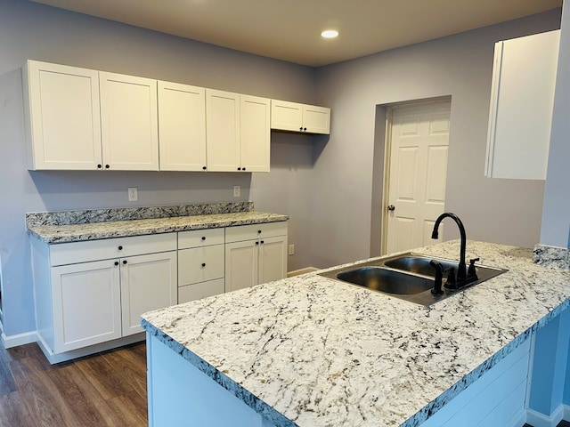 1030 Elm, Bucyrus, OH 44820 - kitchen featuring dark wood-style flooring, white cabinets, a peninsula, recessed lighting, and light stone countertops