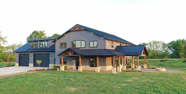 modern inspired farmhouse with a porch, a garage, and a front yard