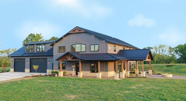 modern farmhouse style home featuring a standing seam roof, concrete driveway, and a front lawn