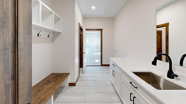 mudroom with light tile patterned floors and sink