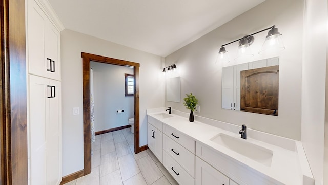 bathroom with tile patterned floors, vanity, and toilet