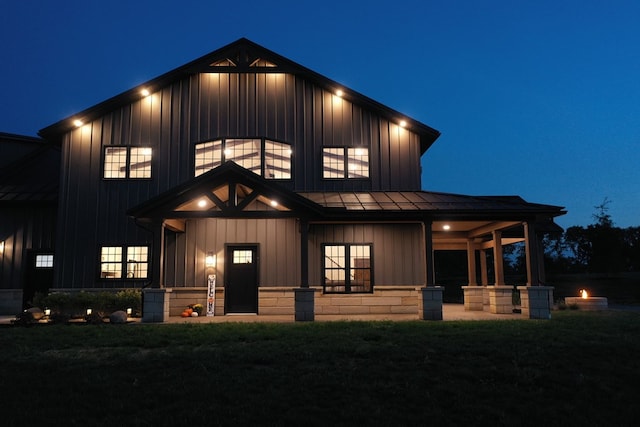 modern farmhouse style home featuring a yard and a fire pit