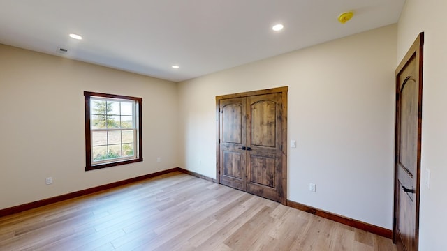 unfurnished bedroom featuring light wood-type flooring