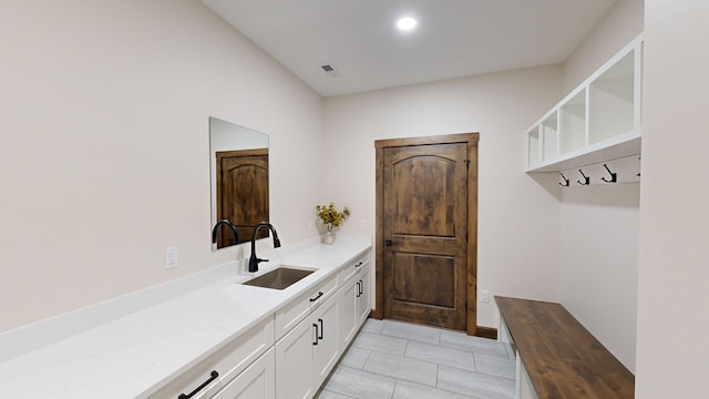 mudroom featuring light tile patterned floors and sink