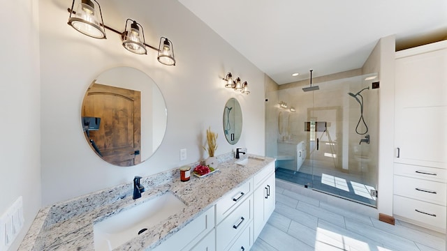 bathroom featuring vanity and a shower with shower door