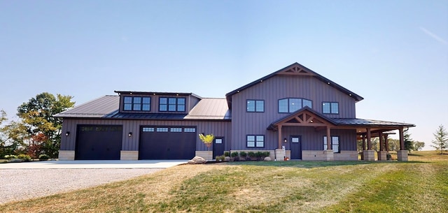 modern farmhouse featuring a front yard and a garage