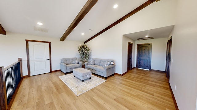 unfurnished living room featuring vaulted ceiling with beams and light wood-type flooring