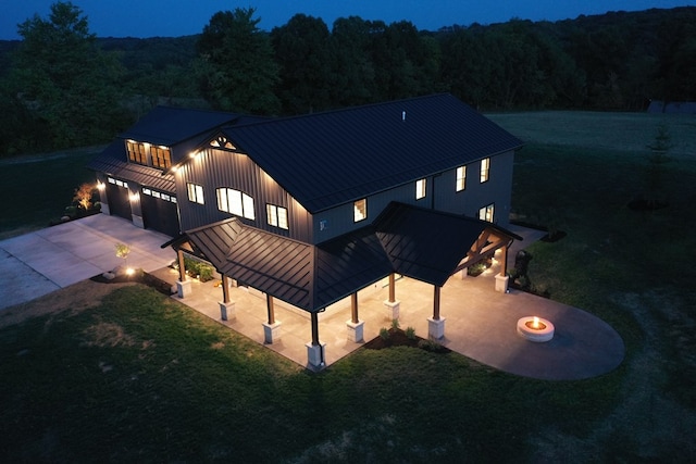 back of house with a gazebo, a yard, and a garage