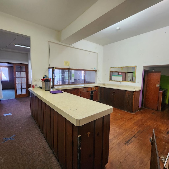 233 E Mansfield St, Bucyrus, OH 44820 - kitchen featuring light countertops, plenty of natural light, a peninsula, and dark brown cabinets