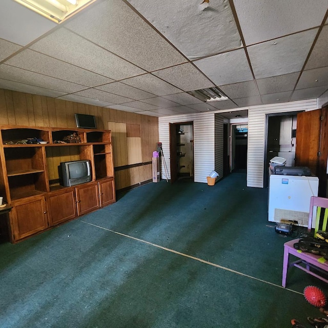 233 E Mansfield St, Bucyrus, OH 44820 - sitting room with baseboards, wood walls, a paneled ceiling, and carpet