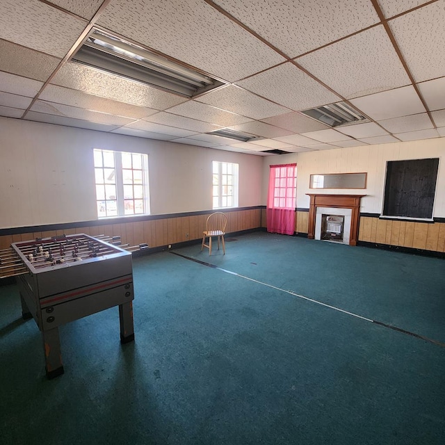 233 E Mansfield St, Bucyrus, OH 44820 - game room featuring wooden walls, a wainscoted wall, carpet flooring, and a paneled ceiling