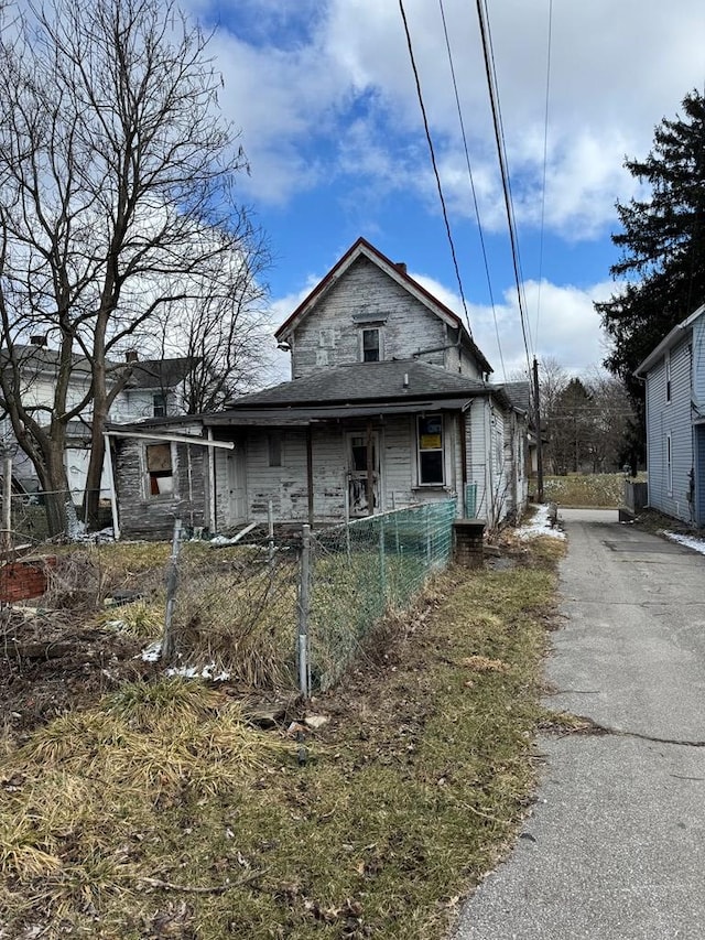 exterior space featuring driveway and fence