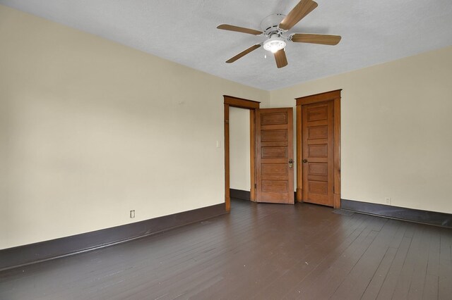 97 S Gamble St, Shelby, OH 44875 - spare room with baseboards, dark wood-style floors, and ceiling fan
