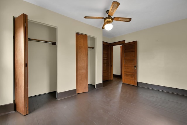 97 S Gamble St, Shelby, OH 44875 - unfurnished bedroom with multiple closets, dark wood-style floors, and a ceiling fan