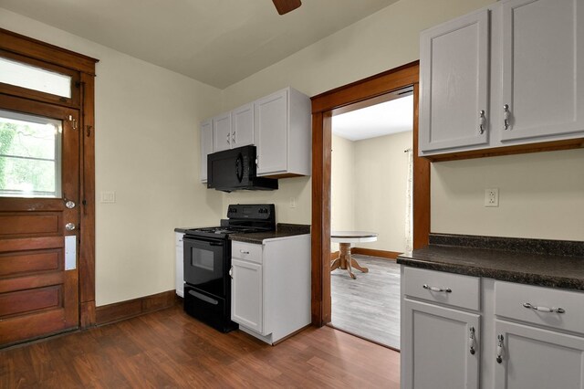 97 S Gamble St, Shelby, OH 44875 - kitchen with black appliances, dark wood-type flooring, dark countertops, and white cabinets