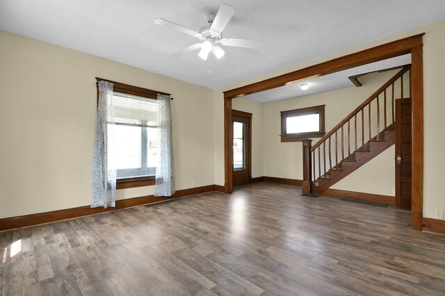 97 S Gamble St, Shelby, OH 44875 - entrance foyer featuring wood finished floors, stairs, baseboards, and ceiling fan