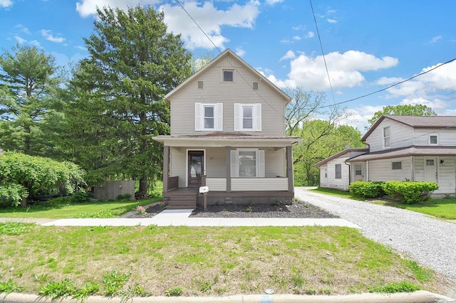 97 S Gamble St, Shelby, OH 44875 - view of front of house with a porch, a front lawn, and driveway