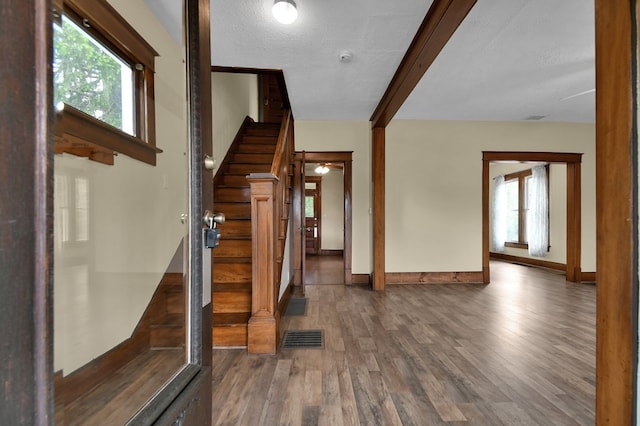 97 S Gamble St, Shelby, OH 44875 - foyer featuring wood finished floors, stairway, healthy amount of natural light, baseboards, and beamed ceiling
