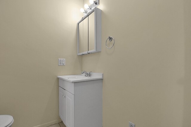 97 S Gamble St, Shelby, OH 44875 - bathroom featuring vanity, tile patterned floors, baseboards, and toilet