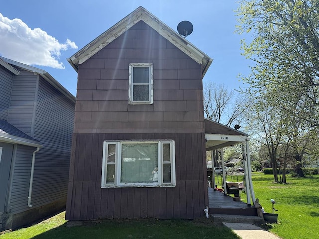 view of side of home featuring a yard