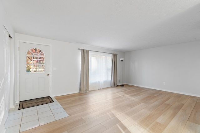 entryway featuring a textured ceiling and light wood-type flooring