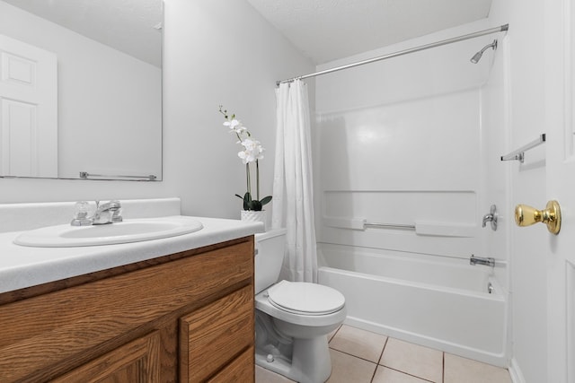 full bathroom with tile patterned flooring, vanity, toilet, a textured ceiling, and shower / bath combo with shower curtain