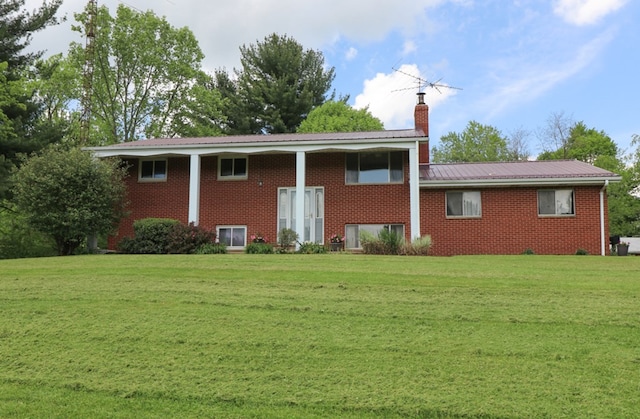 1294 Kings Corners Rd E, Lexington, OH 44904 - rear view of property featuring a yard, a chimney, metal roof, and brick siding