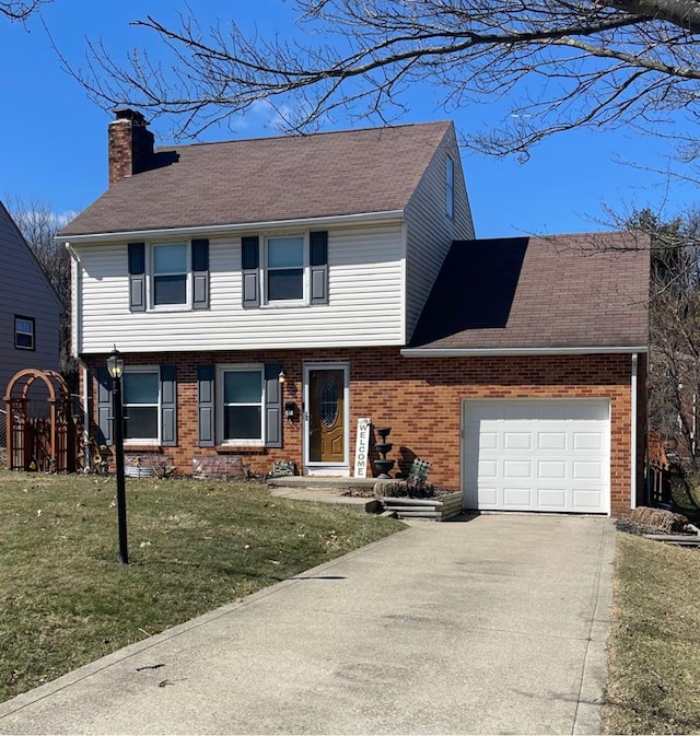 colonial-style house featuring brick siding, concrete driveway, a front yard, a chimney, and an attached garage