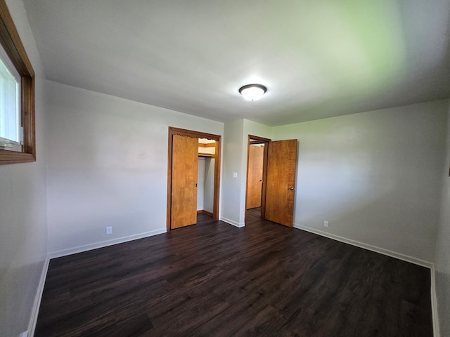 423 Beechwood Dr, Galion, OH 44833 - unfurnished bedroom with dark wood finished floors, baseboards, and a closet