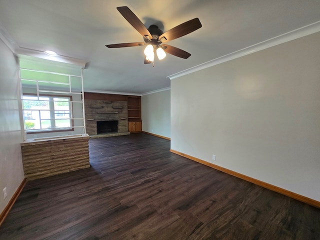 423 Beechwood Dr, Galion, OH 44833 - unfurnished living room with baseboards, ornamental molding, dark wood finished floors, and a stone fireplace