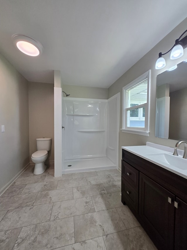 423 Beechwood Dr, Galion, OH 44833 - bathroom with toilet, a walk in shower, vanity, and baseboards
