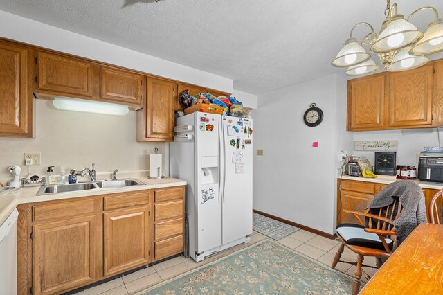 524.526 Rudy Rd, Mansfield, OH 44903 - kitchen with white appliances, a sink, light countertops, light tile patterned floors, and a textured ceiling
