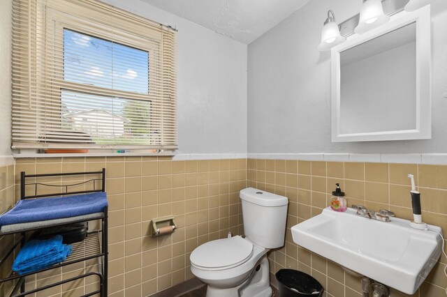 524.526 Rudy Rd, Mansfield, OH 44903 - bathroom featuring a sink, tile walls, toilet, and a wainscoted wall