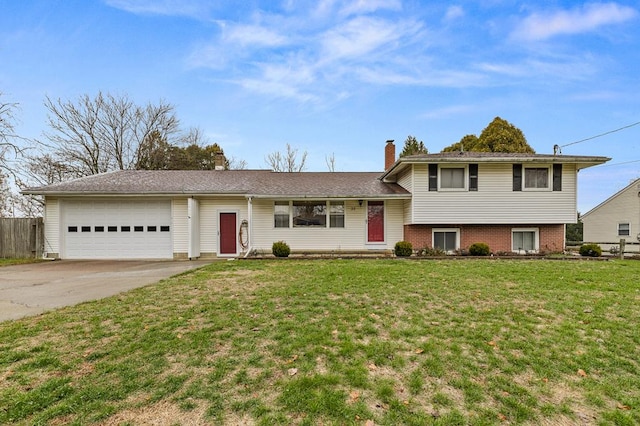 tri-level home featuring a front yard and a garage