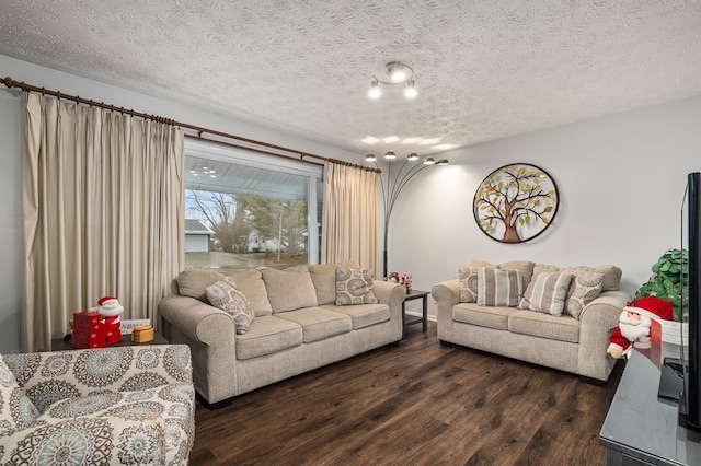 living room featuring a textured ceiling and dark wood-type flooring