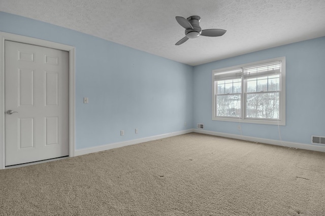 spare room with ceiling fan, carpet floors, and a textured ceiling